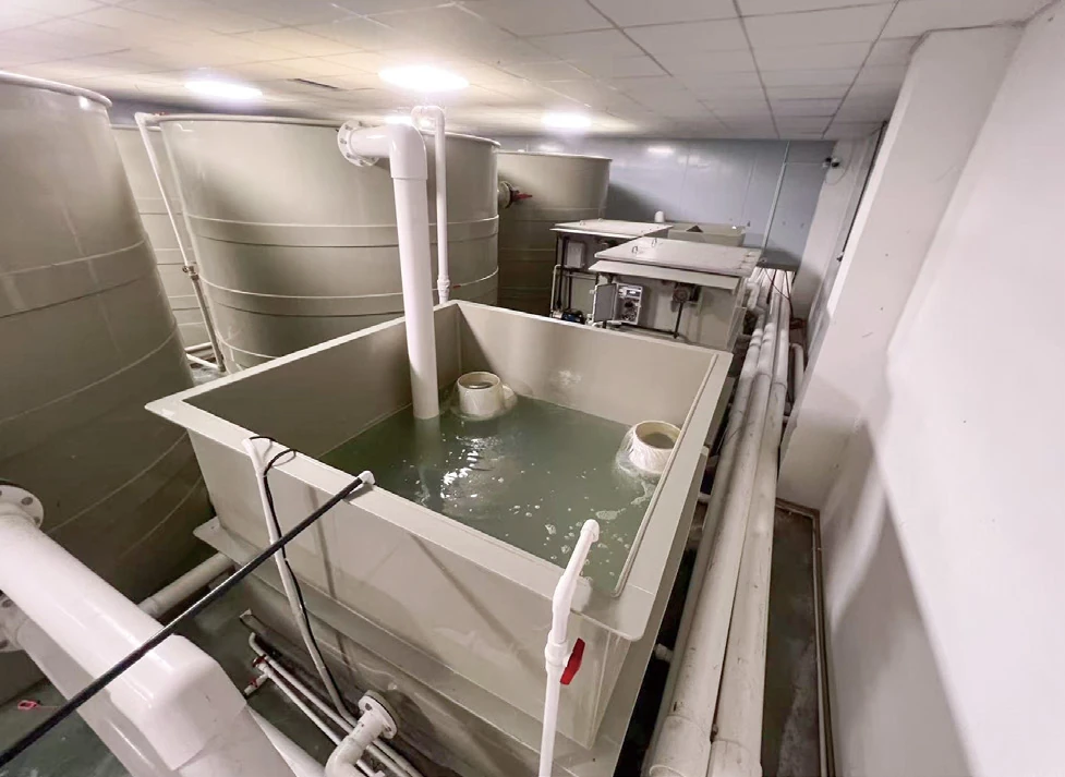 Aquaculture filtration room showing drum filter, treatment tanks and water connection pipework
